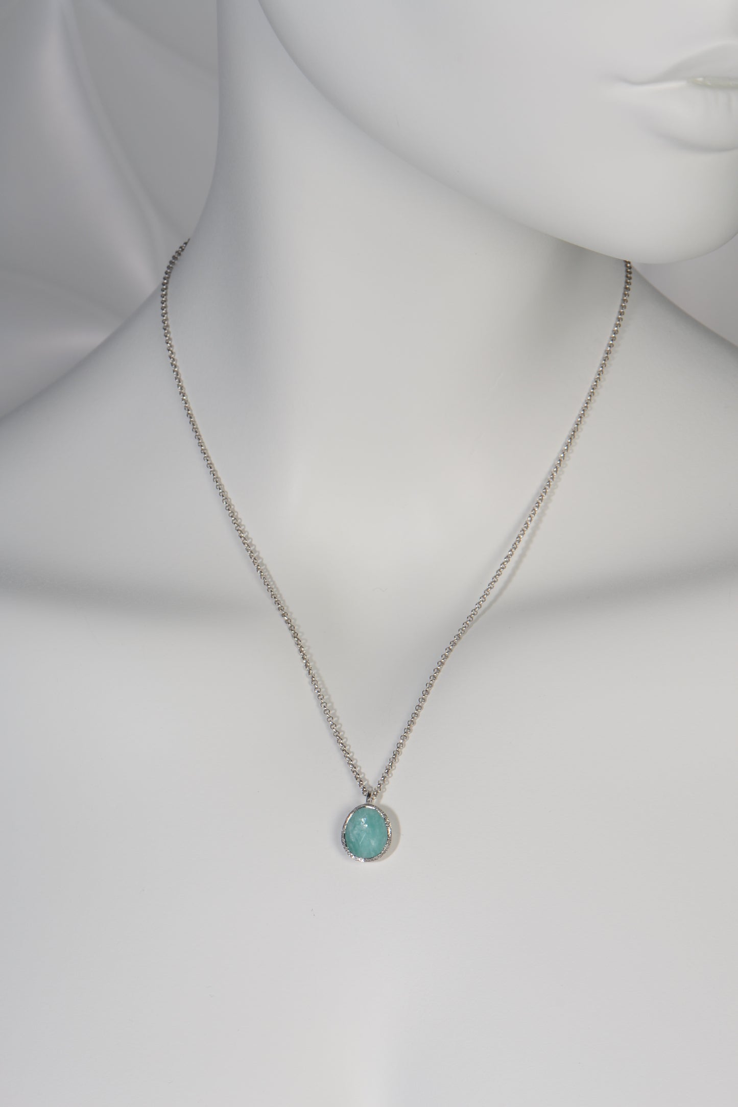 turquoise coloured silver pendant necklace set with the unusual gemstone Aventurine hanging on a fine silver chain by jeweller designer Jorge Revilla