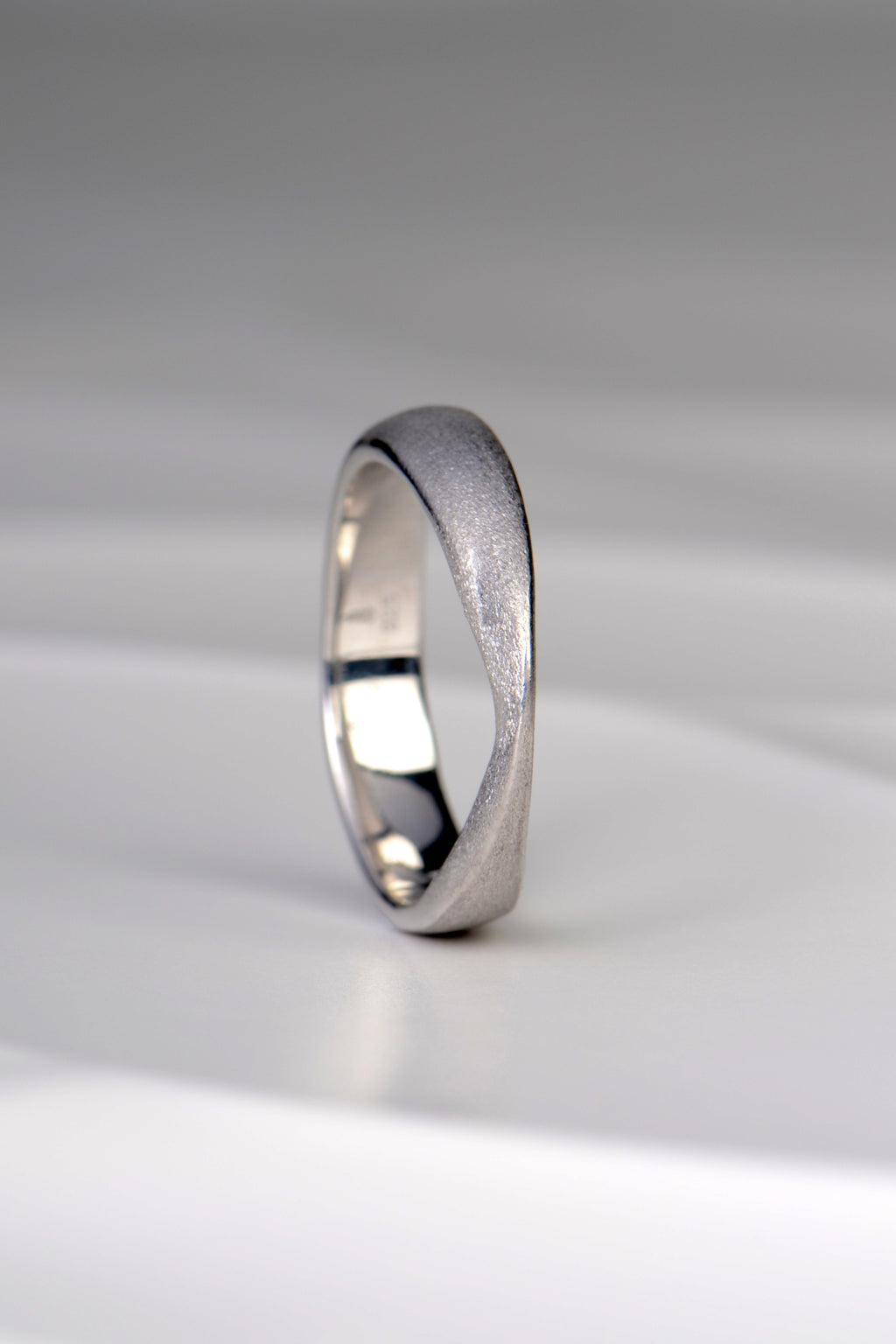 Jorge Revilla brushed silver ring from his forge collection. A modern design that is sculptural and raised to a peak at the front