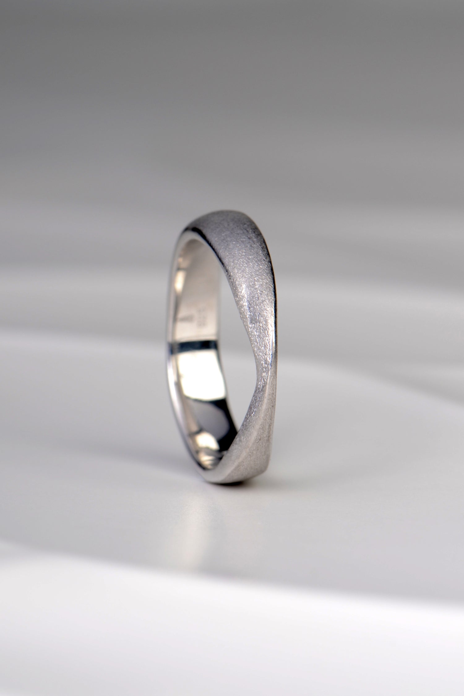Jorge Revilla brushed silver ring from his forge collection. A modern design that is sculptural and raised to a peak at the front