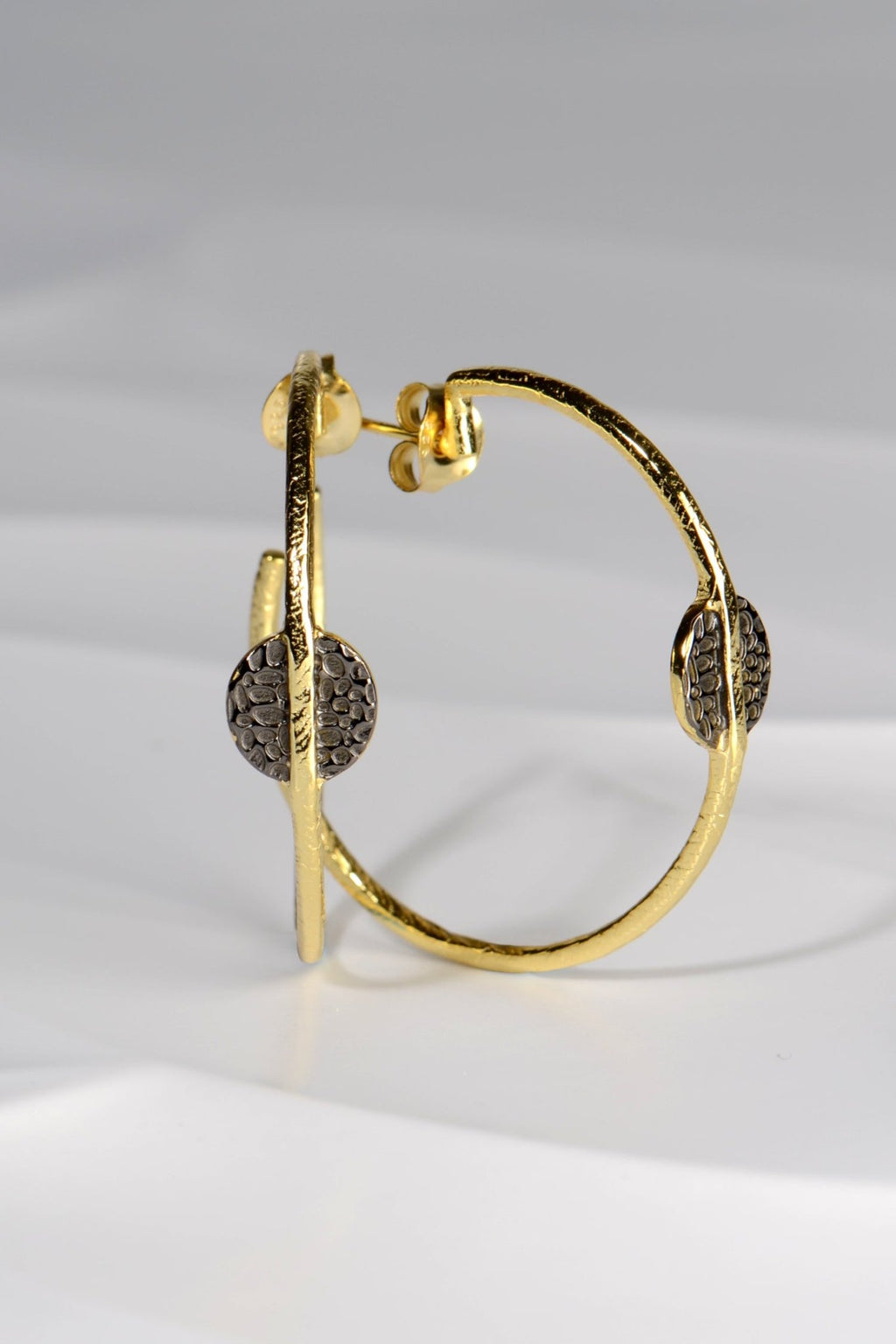 large gold vermeil hoop earrings with black ruthenium detail by jewellery designer Jorge Revilla