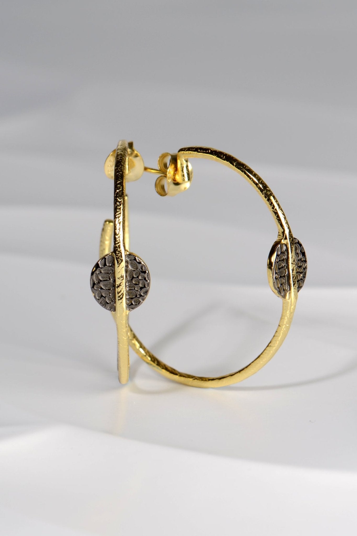 large gold vermeil hoop earrings with black ruthenium detail by jewellery designer Jorge Revilla
