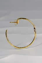 large designer hoop earrings in gold plated silver with an earring post and back fitting by jewellery designer Jorge Revilla