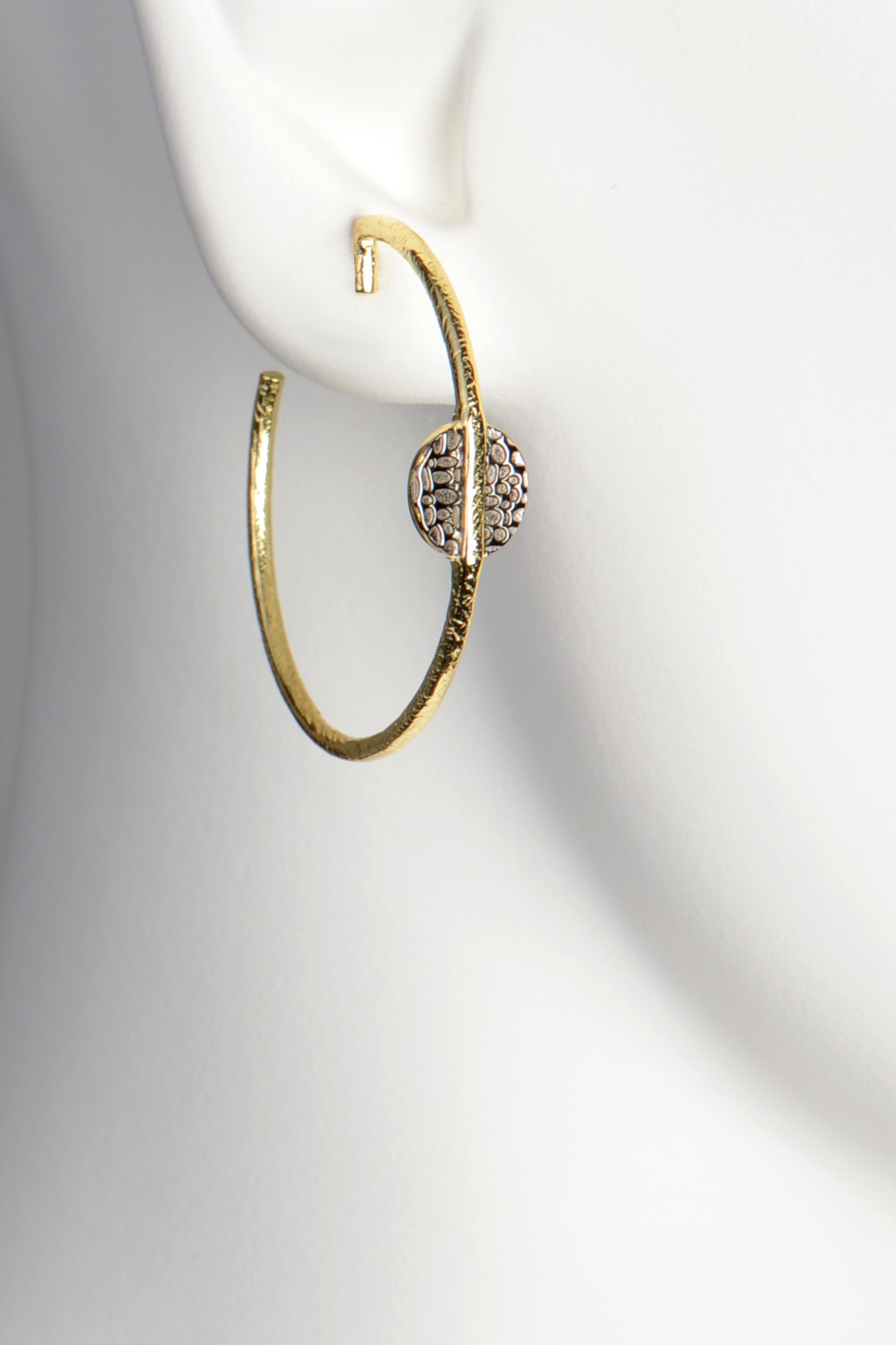 contemporary gold vermeil hoop earrings with an stylish texture by jewellery designer Jorge Revilla