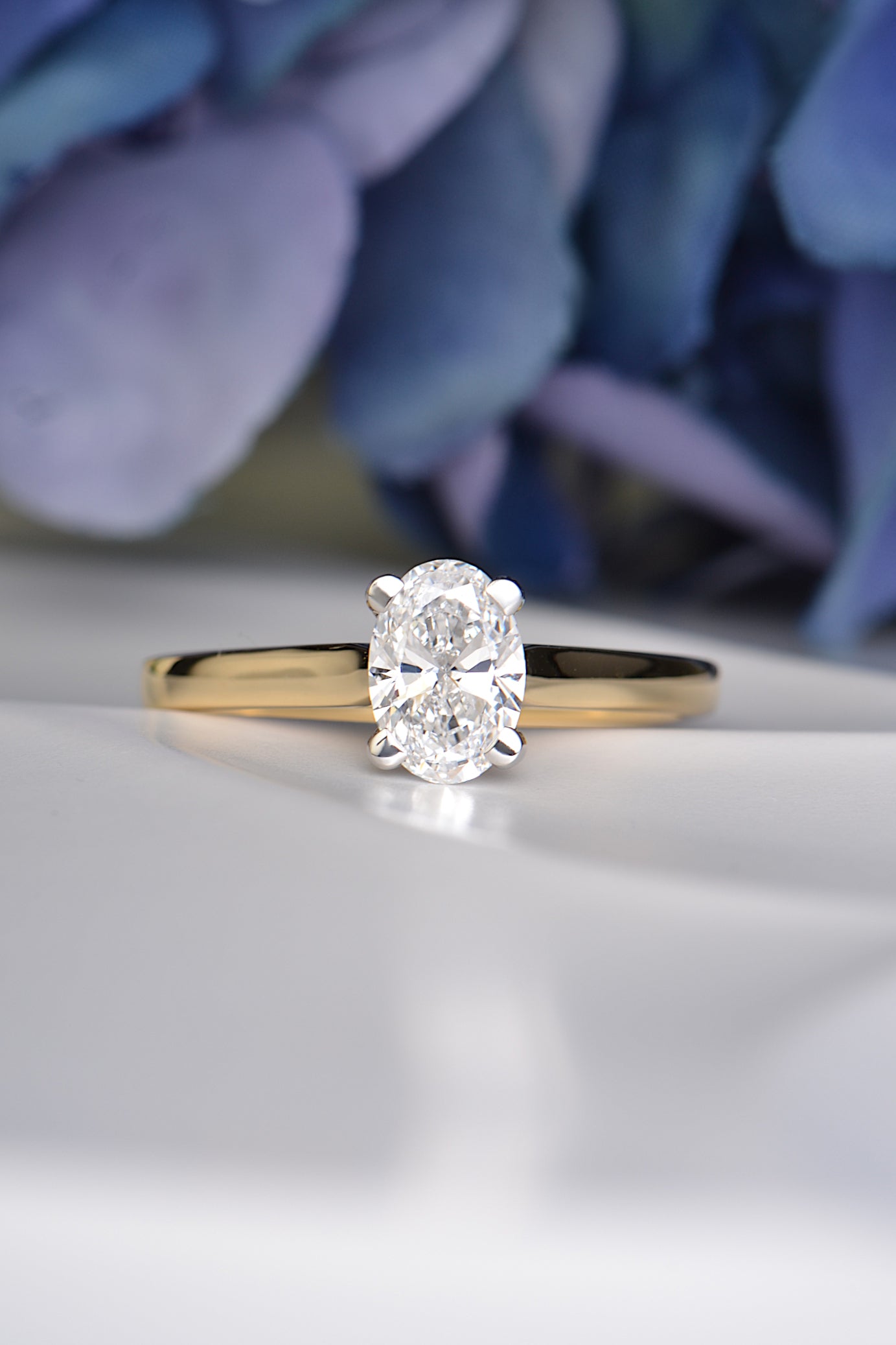Handmade 18ct gold engagement ring with a 1 carat oval lab diamond in platinum claw setting, symbolising lasting love
