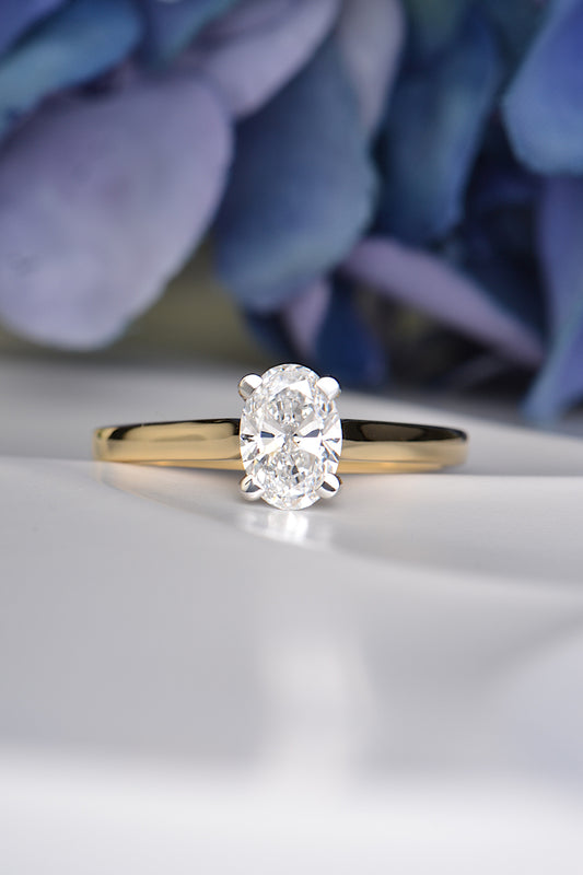 Handmade 18ct gold engagement ring with a 1 carat oval lab diamond in platinum claw setting, symbolising lasting love