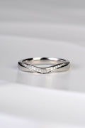 U shaped wedding ring that dips at the front in a sculptural carved way and which has a ribbon of brilliant cut diamonds following the curve