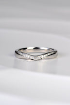 U shaped wedding ring that dips at the front in a sculptural carved way and which has a ribbon of brilliant cut diamonds following the curve
