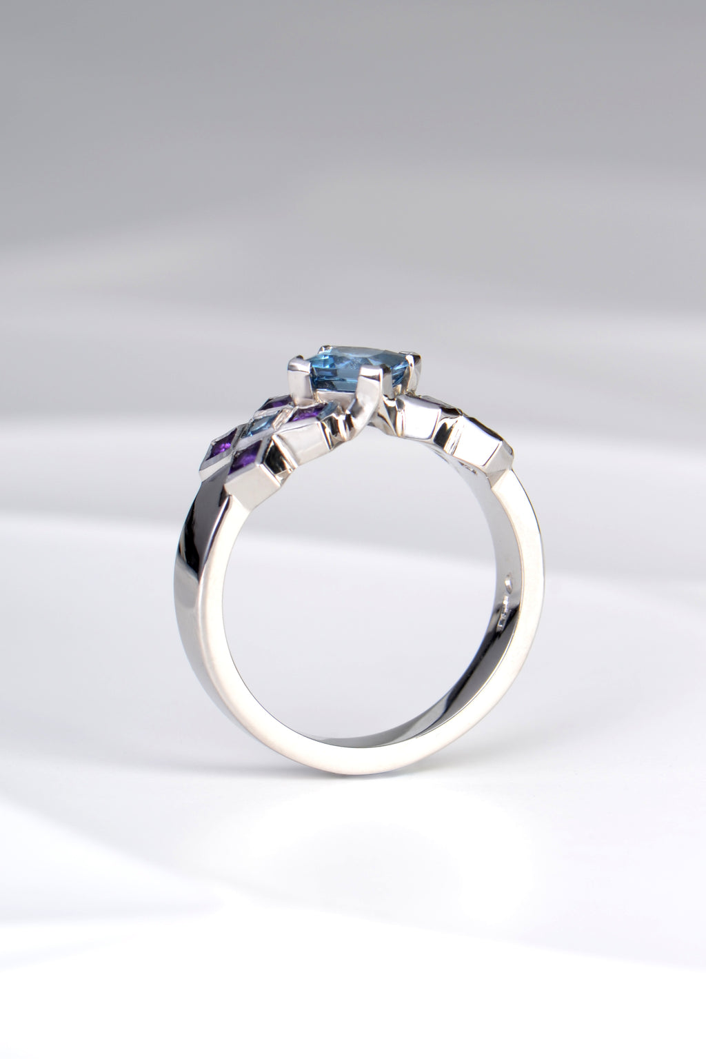 side view of contemporary platinum engagement ring without diamonds made with Aquamarine and amethysts by jewellery designer Christine Sadler