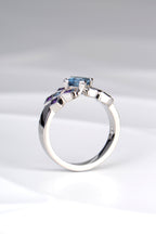 side view of contemporary platinum engagement ring without diamonds made with Aquamarine and amethysts by jewellery designer Christine Sadler