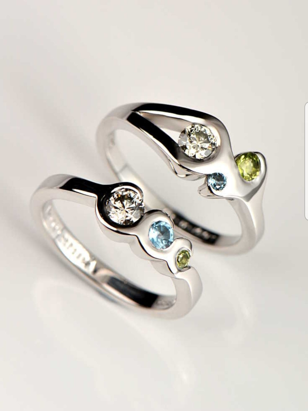two unique gemstone rings, one to represent fire and one to represent water from British jewellery designer Christine Sadler