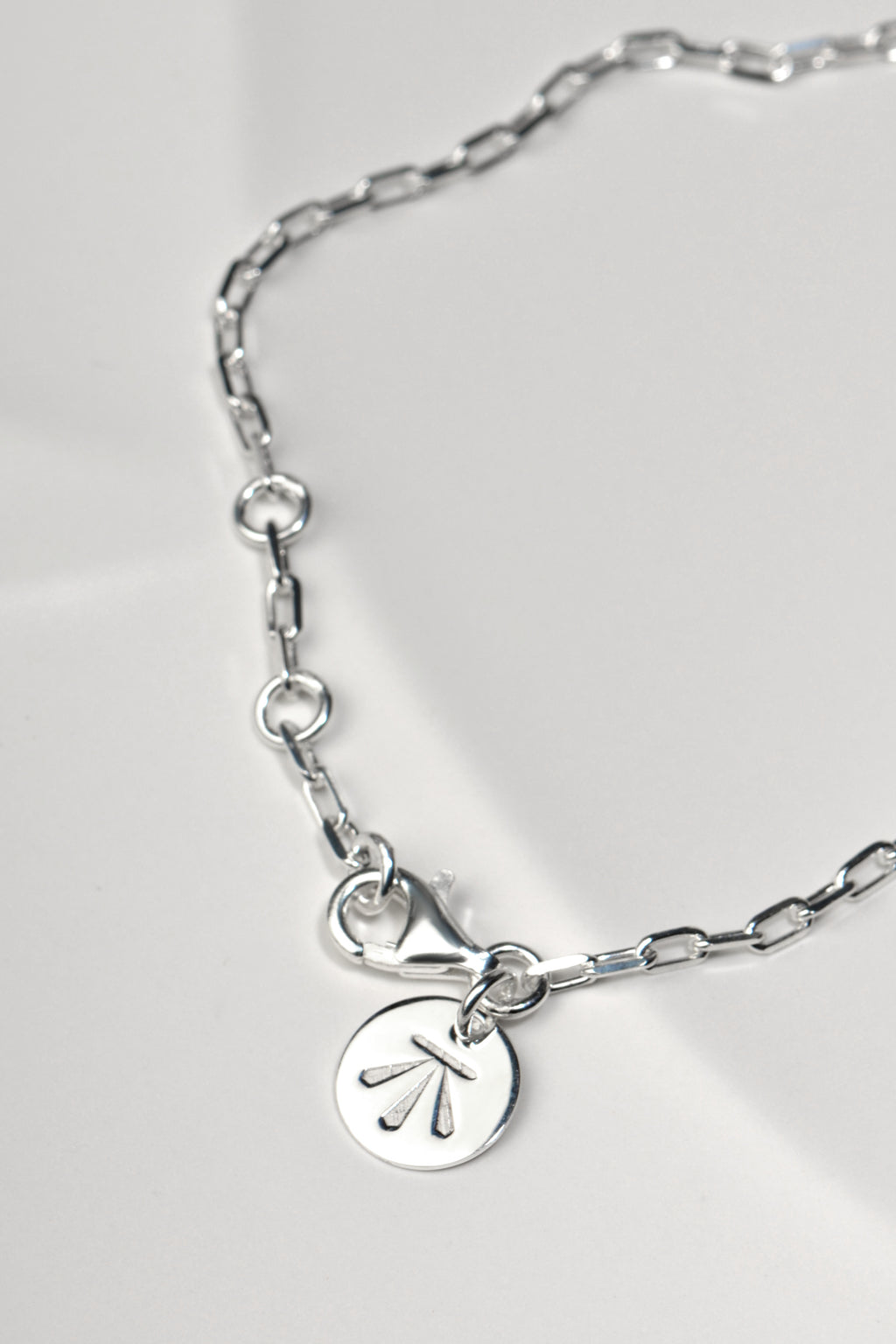 close up detail of the adjustable rings that the Sterling silver two‑heart bracelet with aquamarine can be fastened into to change the length
