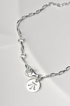 close up detail of the adjustable rings that the Sterling silver two‑heart bracelet with aquamarine can be fastened into to change the length