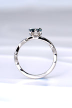 side view of the platinum and diamond heart cut Alexandrite colour change ring showing the sculptural design of the tiny flames that rise up to hold the gemstone