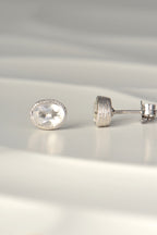 handmade silver earrings set with oval white topaz