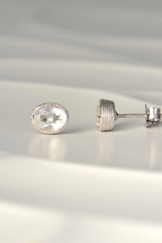 handmade silver earrings set with oval white topaz