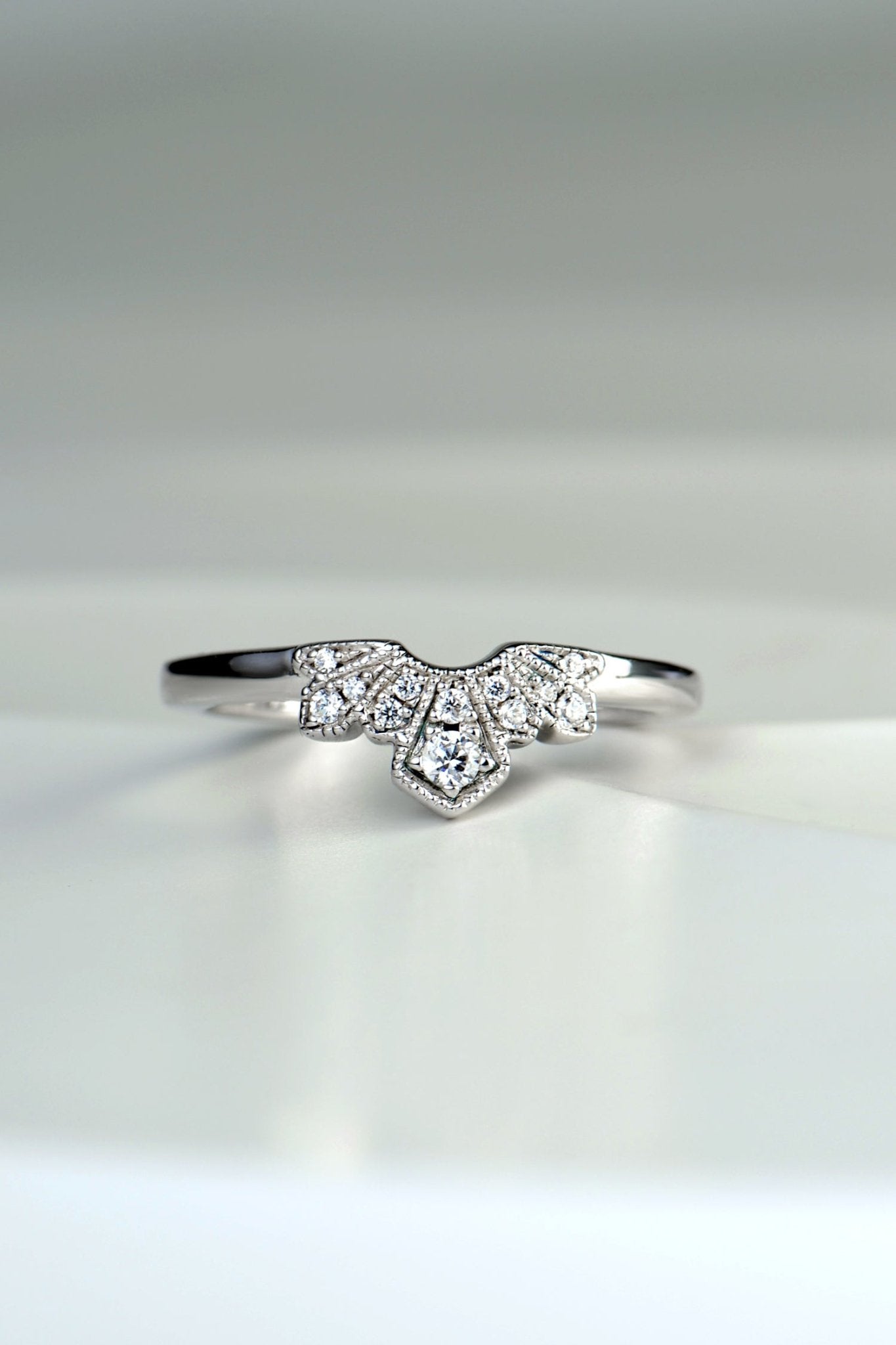 art deco style wedding ring set with diamond if a fan shaped detail at the front