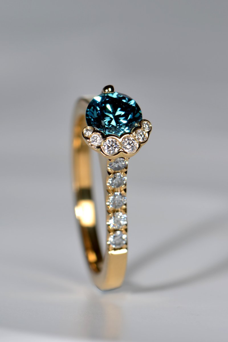 scottish blue diamond engagement ring in yellow gold exclusively available from jewellery designer Christine Sadler inspired by the fairy pools on the Isle of Skye