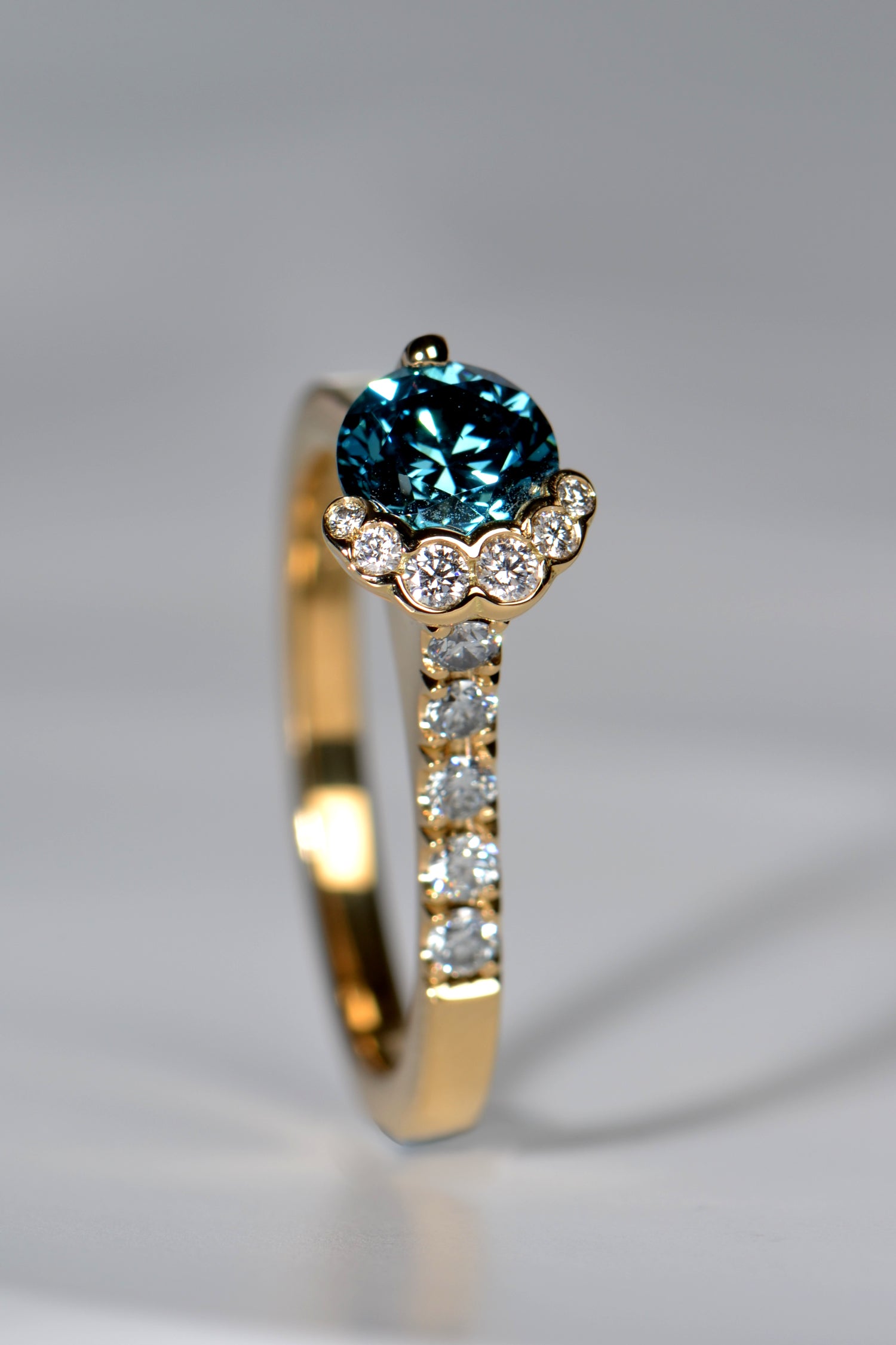 Scottish designer diamond engagement ring that is unusual and collectable set with blue and white diamonds in 18ct yellow gold
