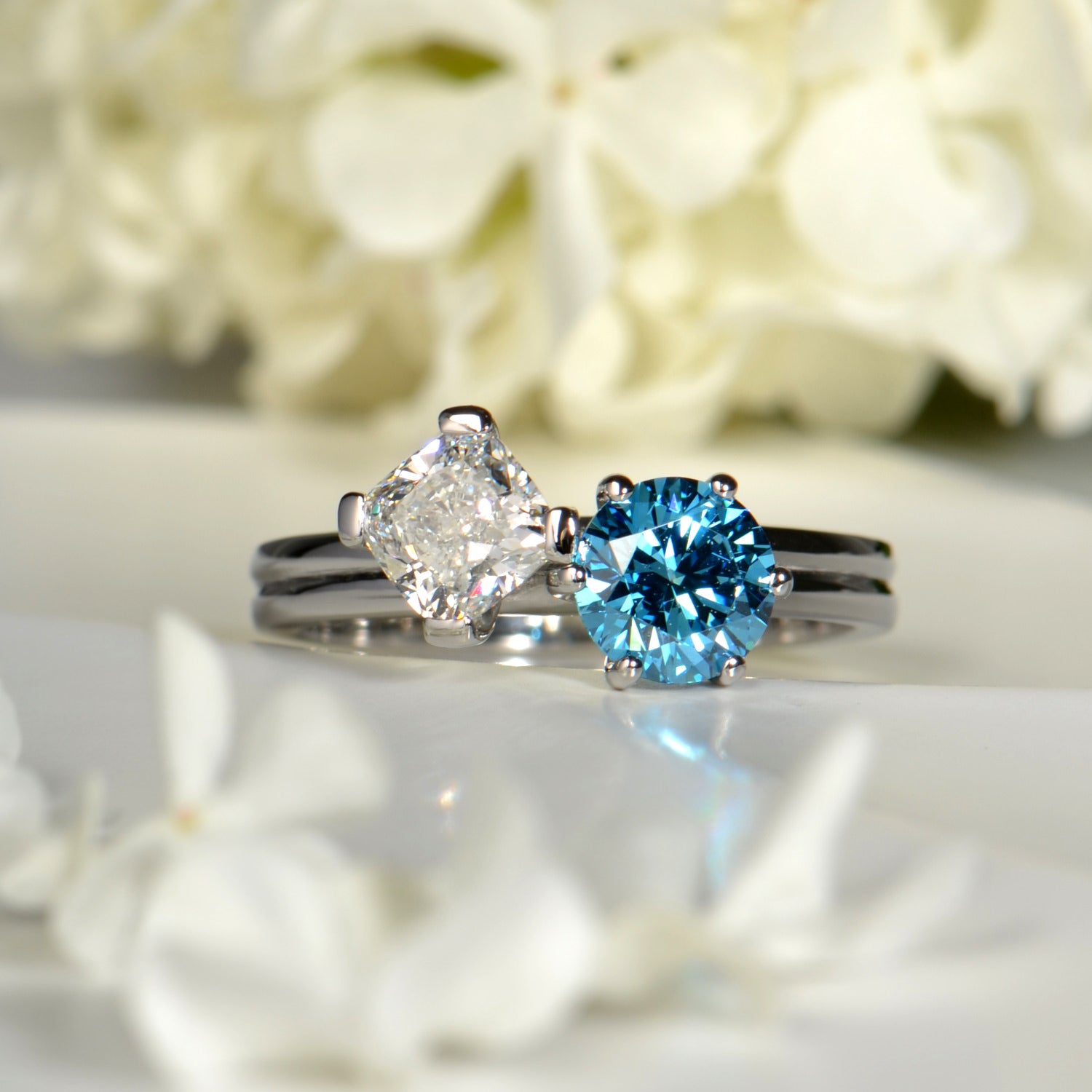 Unique white and blue diamond moi et toi engagement ring commission designed by Christine Sadler