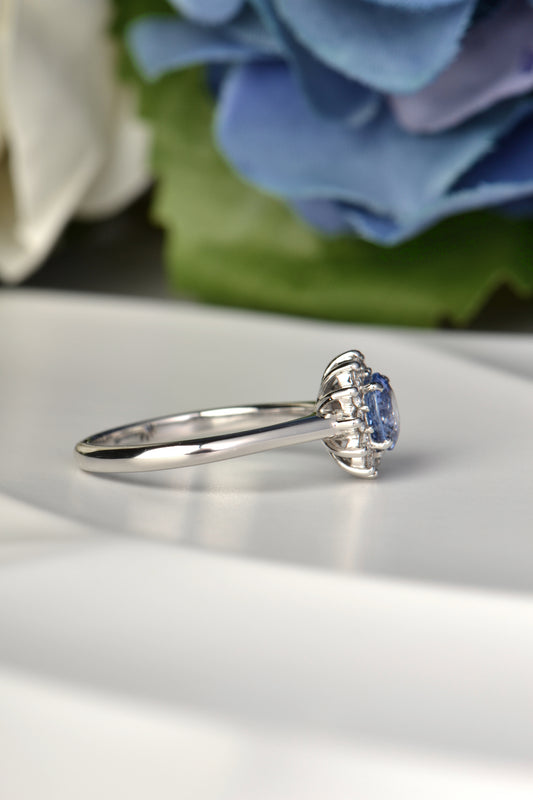 Blue sapphire engagement ring with diamond flower design by Christine Sadler