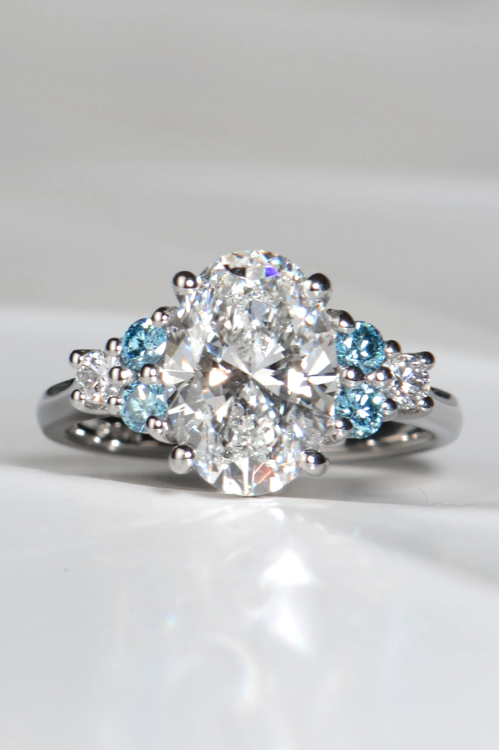 Blue Sky Spark platinum ring with 3.09ct oval lab diamond and vivid blue lab diamond accents