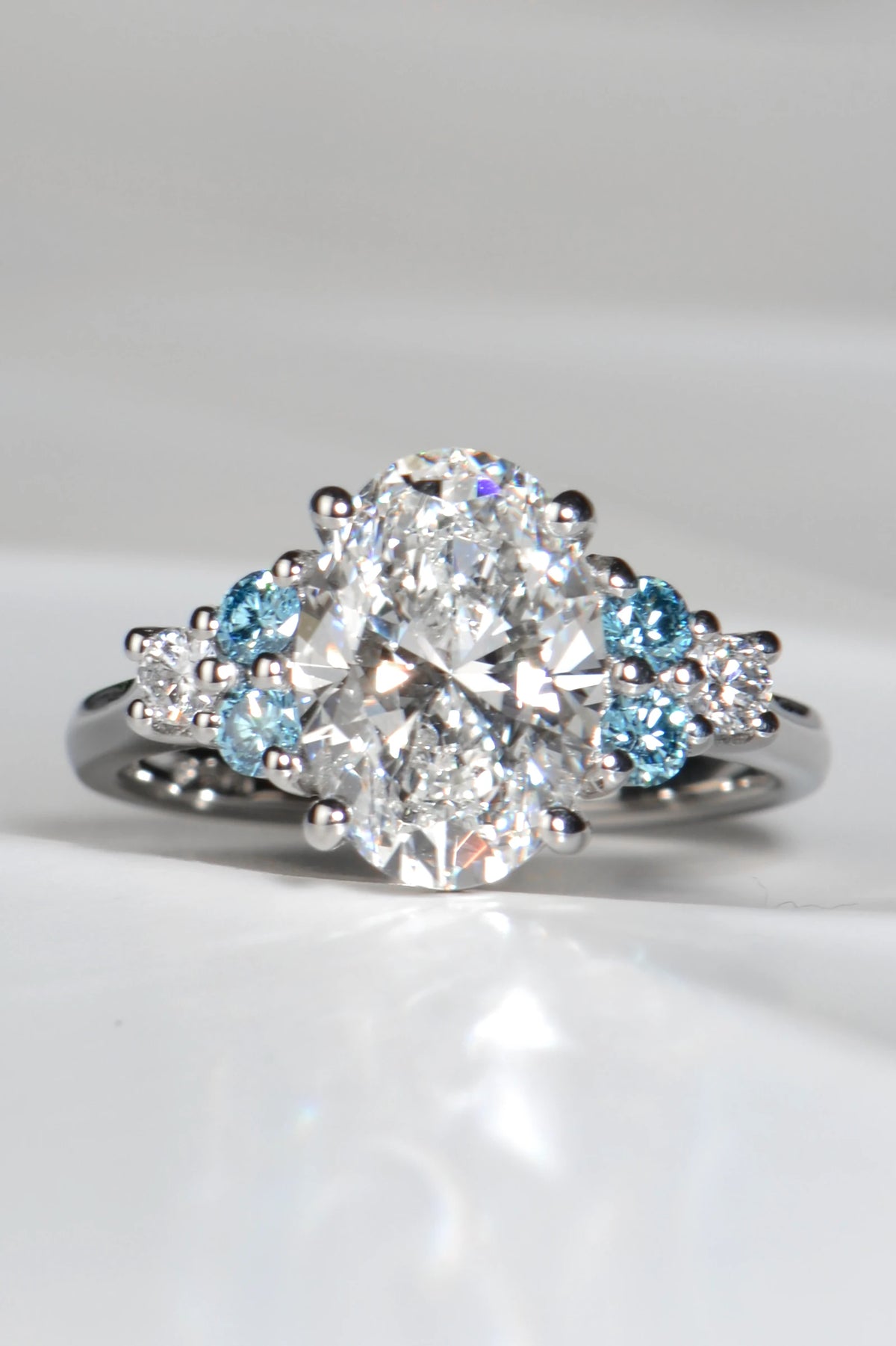 Blue Sky Spark platinum ring with 3.09ct oval lab diamond and vivid blue lab diamond accents