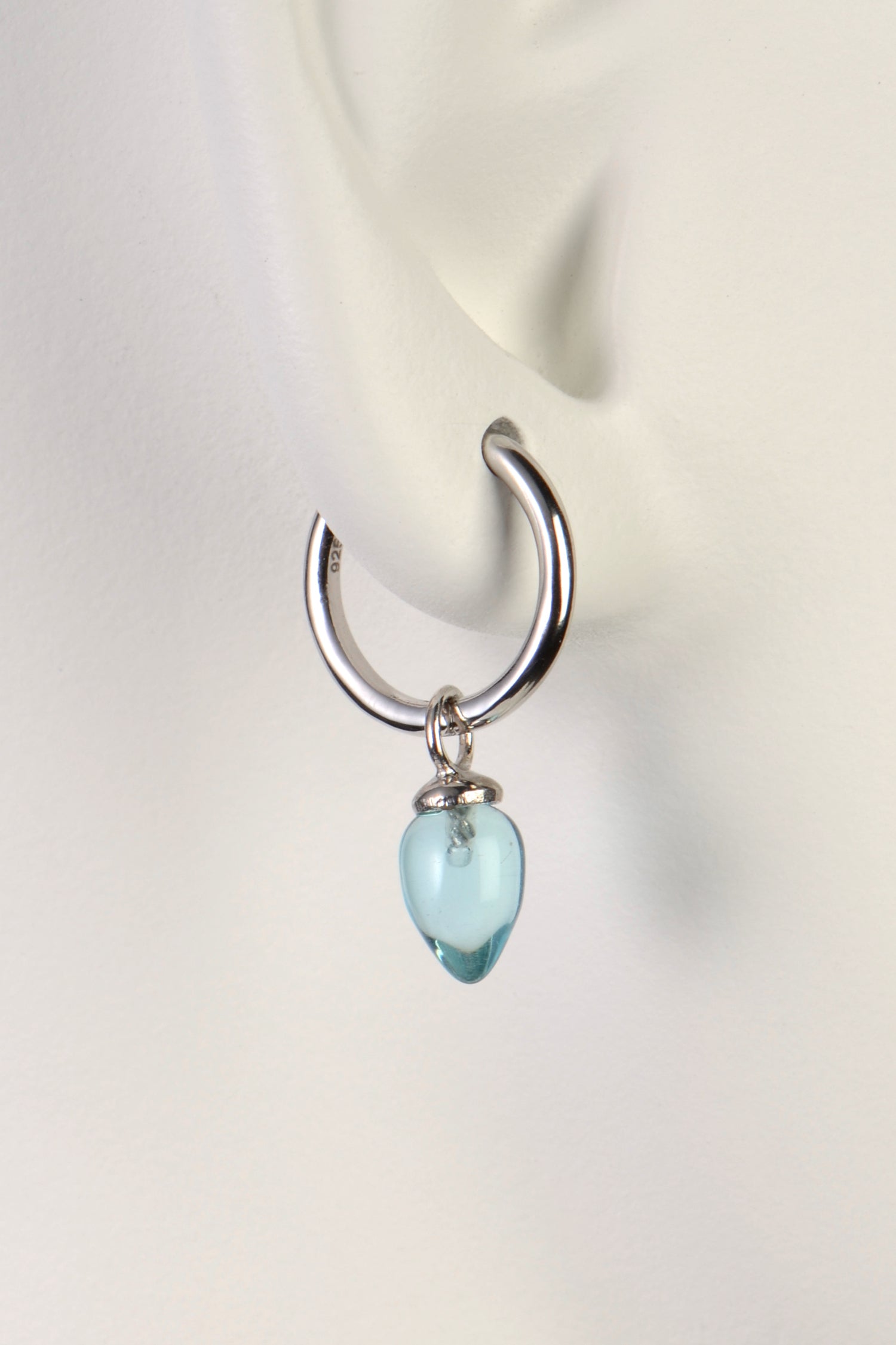 beautiful blue topaz gemstones hanging from real silver small hoop earrings