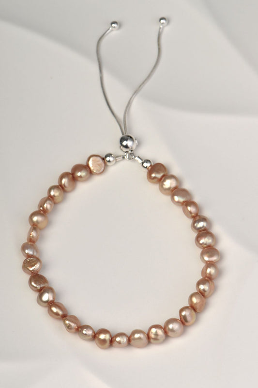 pale brown cultured pearl bracelet with a sliding silver clasp that is adjustable to fit any wrist size and easy to put on and off.
