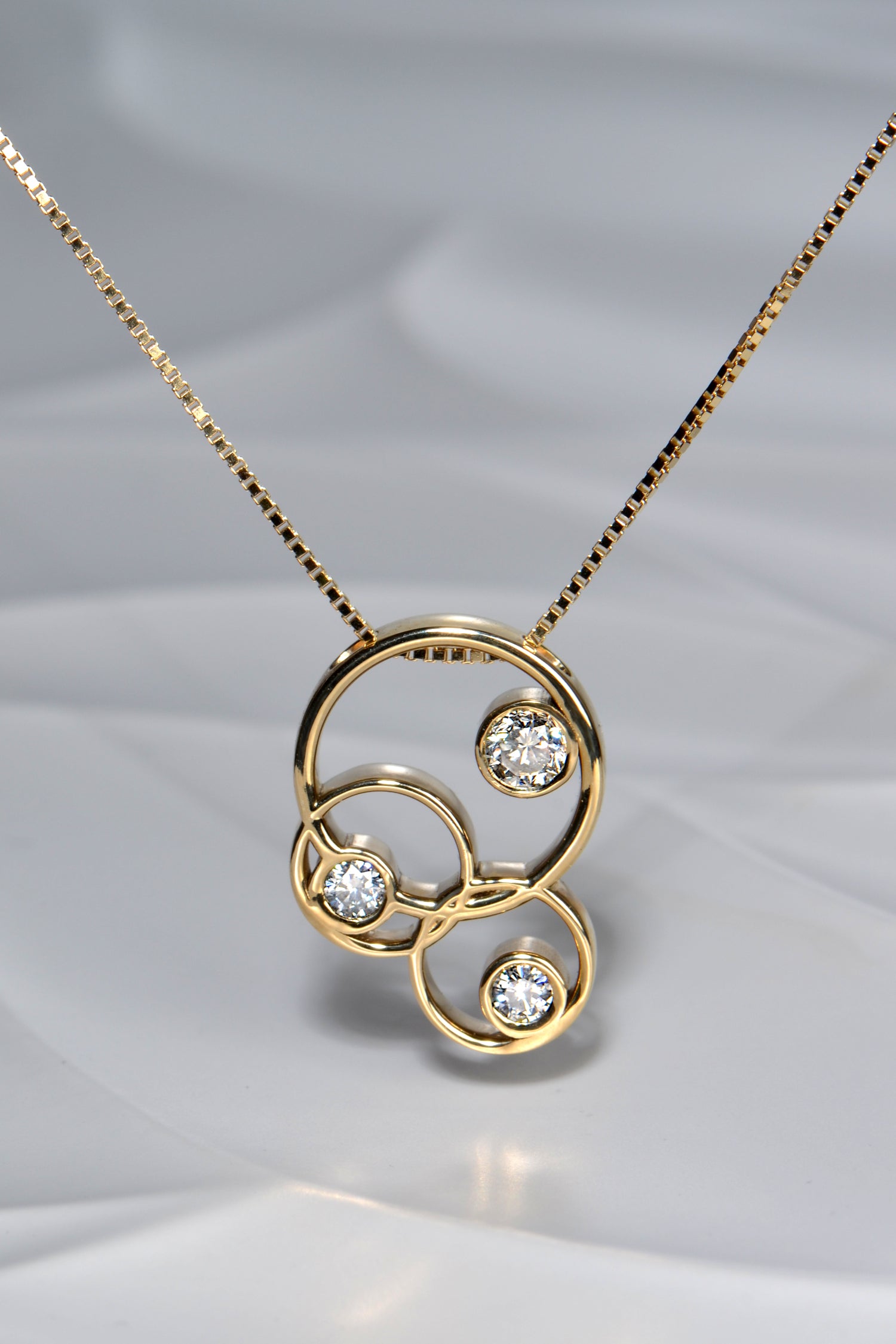Modern interlocked gold circle pendant made using heirloom jewellery - remodelling by Christine Sadler