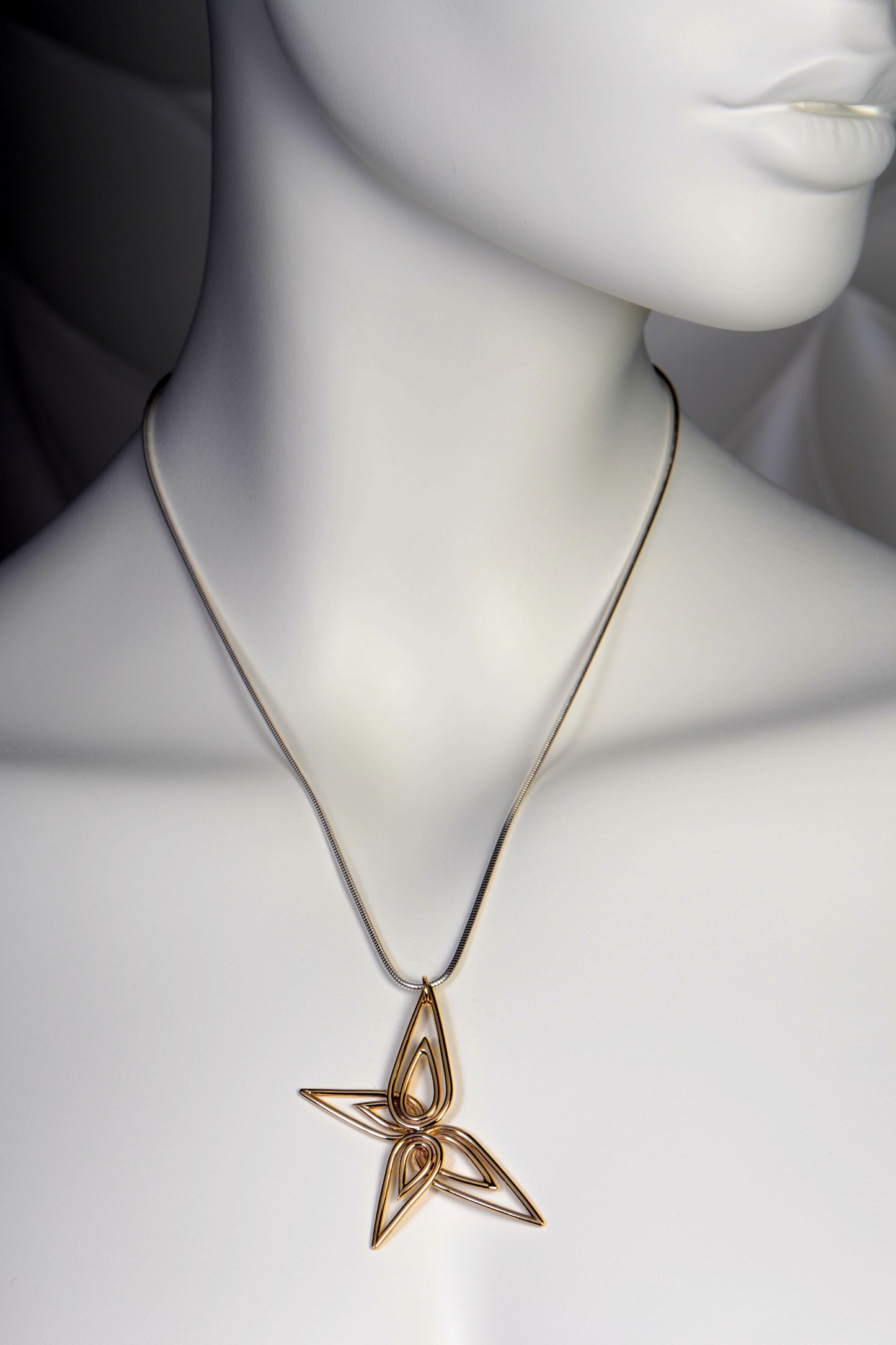 large gold butterfly pendant on silver chain