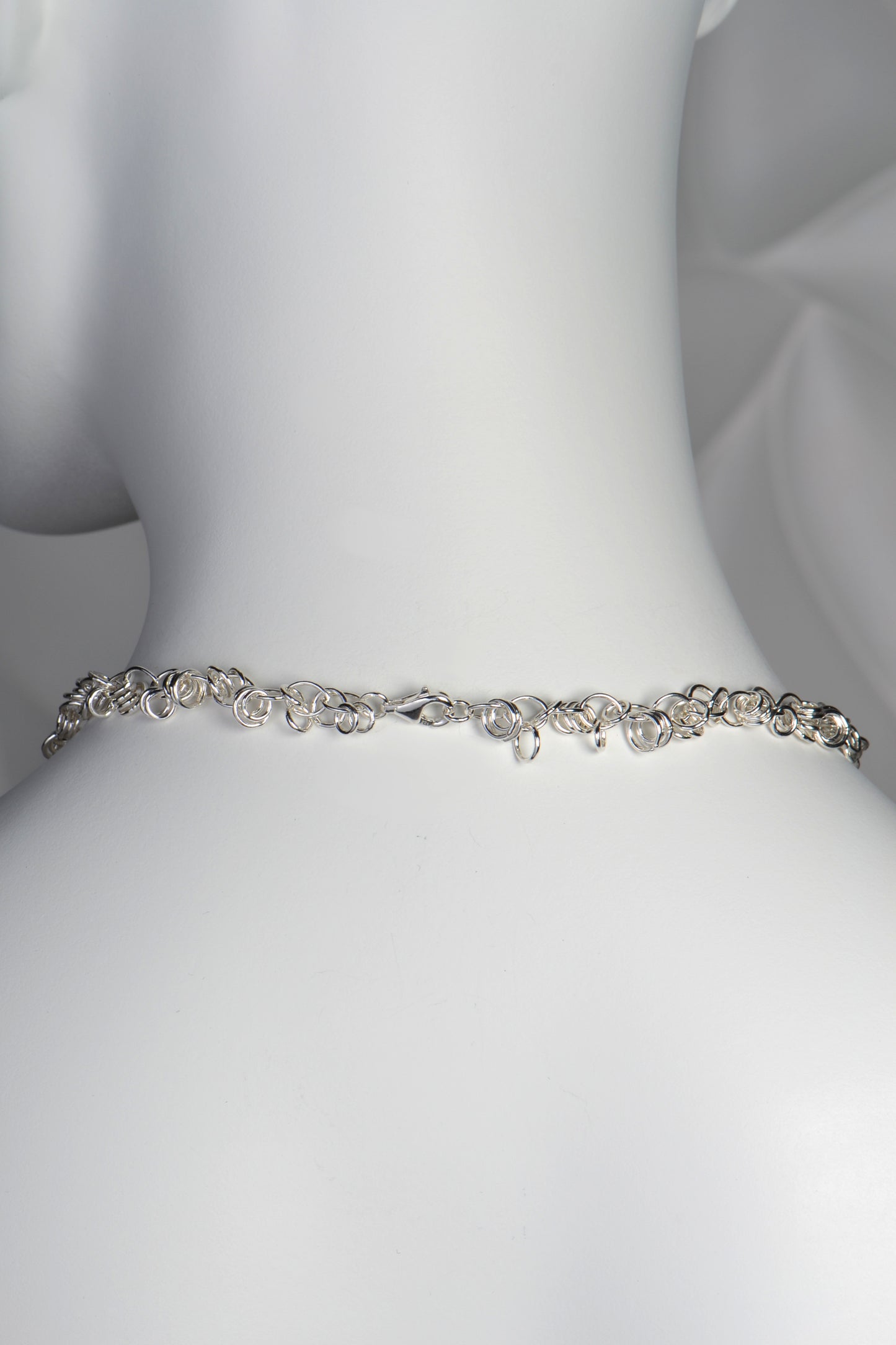 back of the chain link necklace showing the silver shackle clasp
