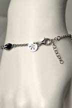 modern silver charm bracelet with Christine Sadler's benchmark logo