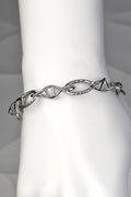 Sterling silver Designer Genes bracelet with four DNA helix links and five thread-like oval links, designed by Christine Sadler.