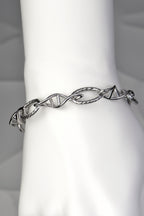 Sterling silver Designer Genes bracelet with four DNA helix links and five thread-like oval links, designed by Christine Sadler.