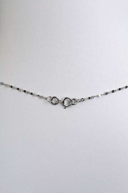 detail showing a small round bolt ring clasp on this delicate platinum chain