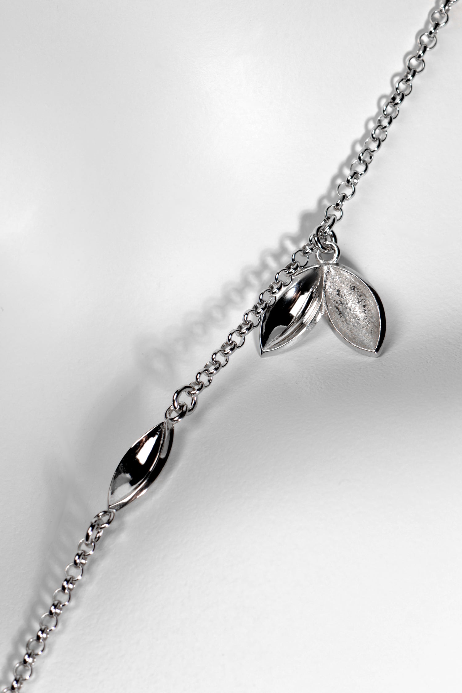Modern seed shaped silver charm necklace. Called The Promise, for each one sold a tree is planted in Scotland
