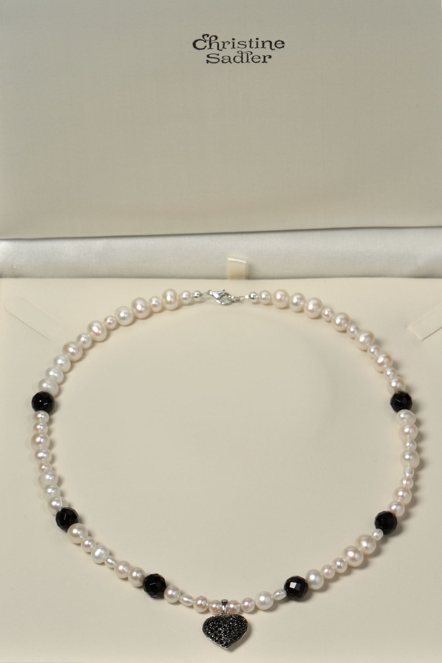 Black onyx and white cultured pearl necklace with black onyx gemstones in a presentation box with Christine Sadler branding