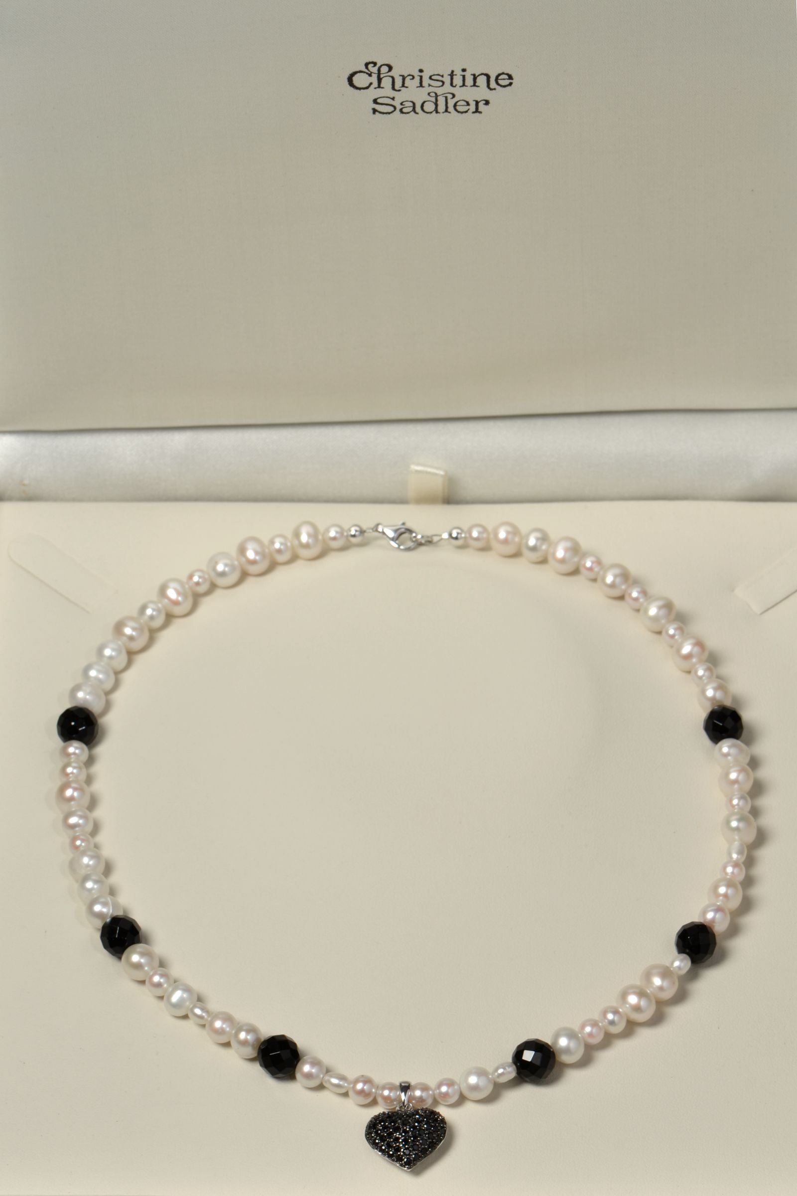 Black onyx and white cultured pearl necklace with black onyx gemstones in a presentation box with Christine Sadler branding
