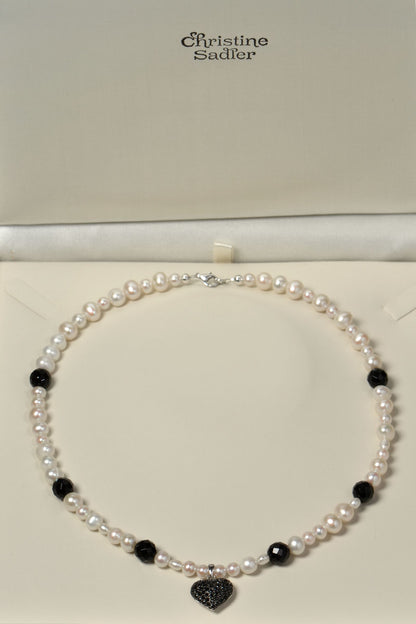 Black onyx and white cultured pearl necklace with black onyx gemstones in a presentation box with Christine Sadler branding