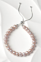 Real cultured pearl bracelet in pale pink with a sterling silver clasp on a white textured tile - Christine SSadler