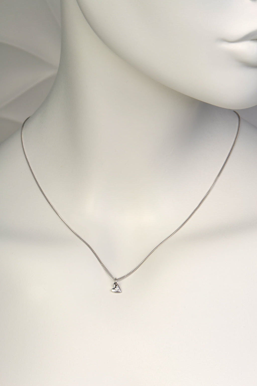 Delicate white gold heart necklace with diamond on mannequin to show scale- Christine Sadler