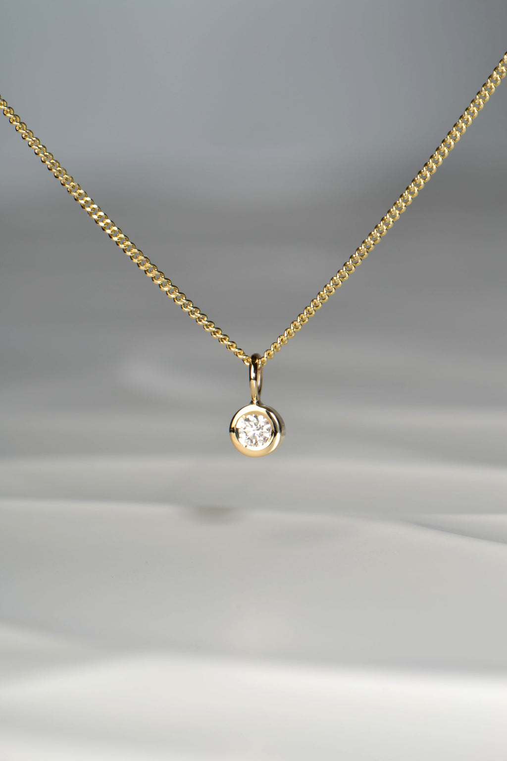 Handmade petite yellow gold circle pendant set with a 0.10ct lab diamond - Christine Sadler