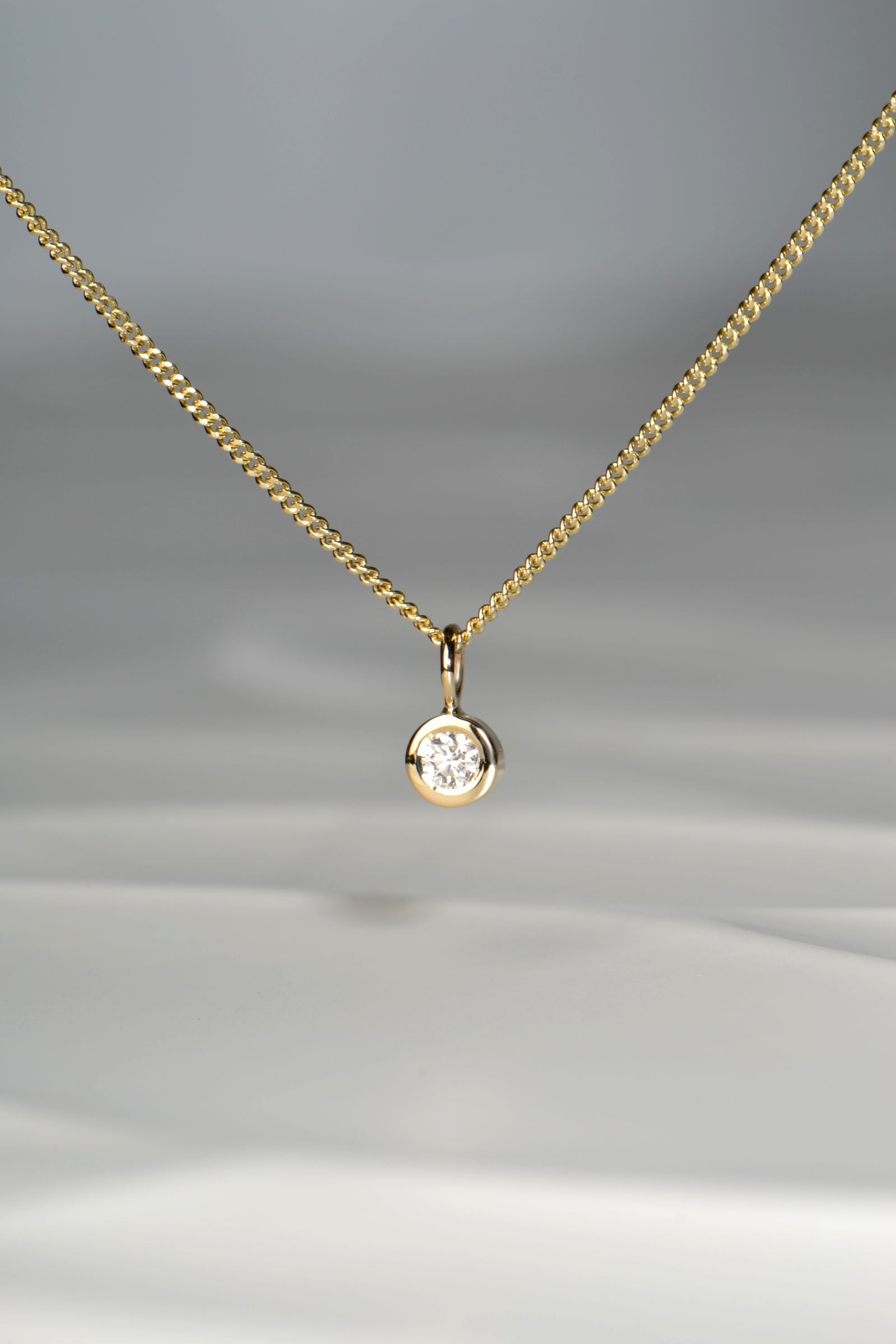 Handmade petite yellow gold circle pendant set with a 0.10ct lab diamond - Christine Sadler