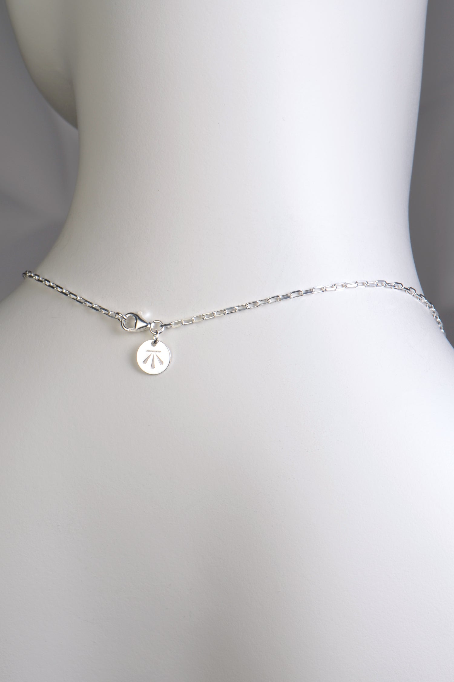 detail of the back of the necklace showing the clasp and branded silver tag of Christine Sadler Unforgettable Jewellery