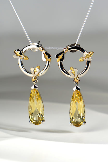 luxury fine jewellery platinum earrings that are one of a kind with long pear cut yellow beryl gemstones to look like dripping honey by contemporary jewellery designer Christine Sadler
