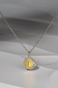 small circular pendant with a gold vermeil bee design on a silver chain - Jorge Revilla jewellery designer