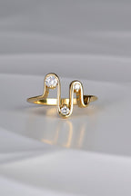 an 18ct yellow gold wavy ring with four waves and three diamonds inspired by a heartbeat