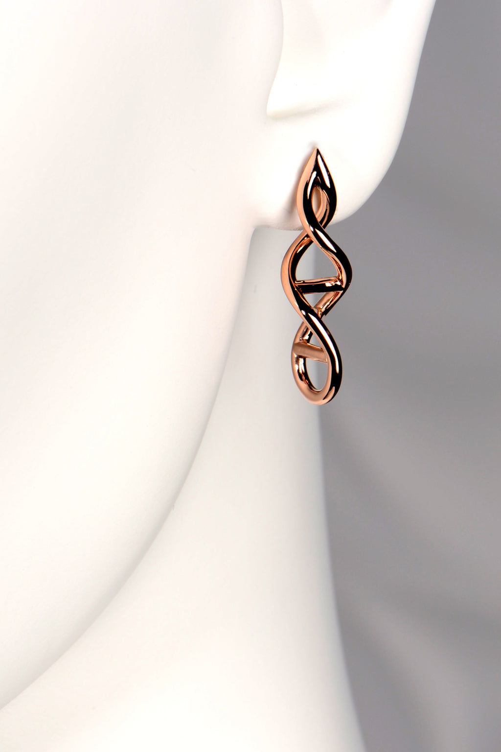 Designer Genes earrings in 9ct rose gold shown on mannequin to display their size and elegant drop. - Christine Sadler
