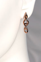 Designer Genes earrings in 9ct rose gold shown on mannequin to display their size and elegant drop. - Christine Sadler