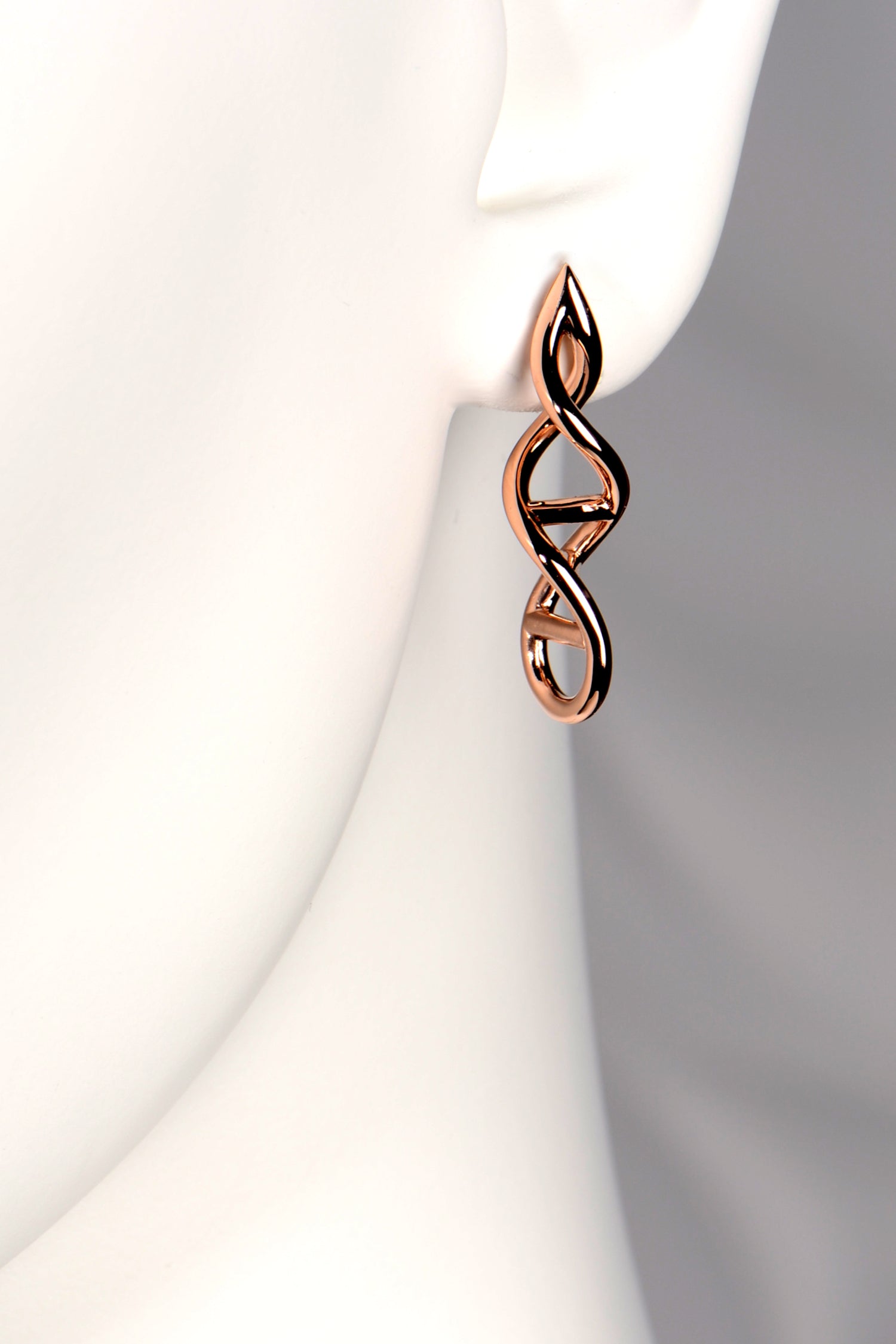 Designer Genes earrings in 9ct rose gold shown on mannequin to display their size and elegant drop. - Christine Sadler